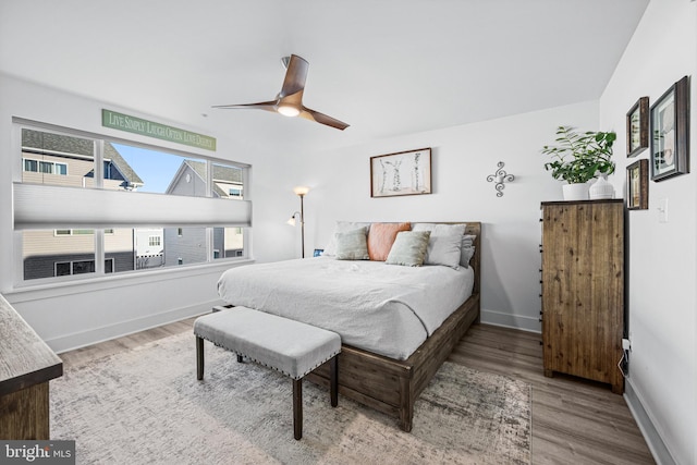 bedroom featuring ceiling fan, wood finished floors, and baseboards