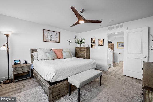 bedroom featuring baseboards, a ceiling fan, and light wood-style floors