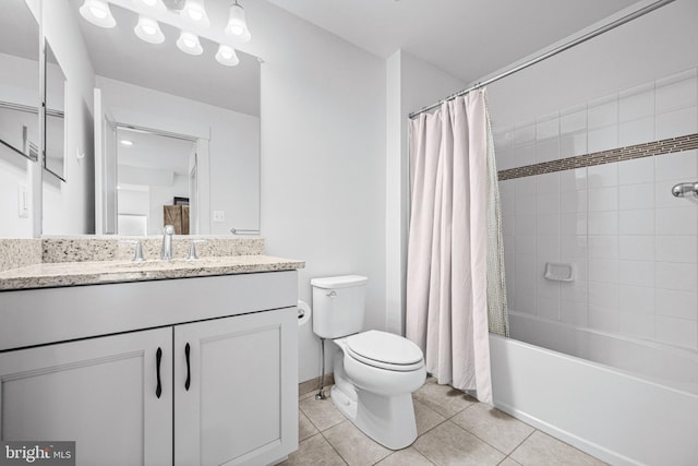 full bathroom featuring toilet, vanity, baseboards, tile patterned floors, and shower / bath combo with shower curtain