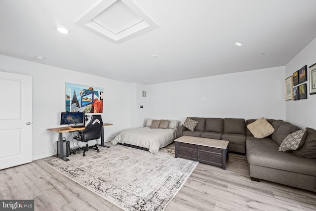 bedroom with wood finished floors, attic access, and recessed lighting