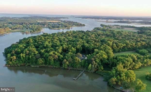 aerial view at dusk featuring a water view