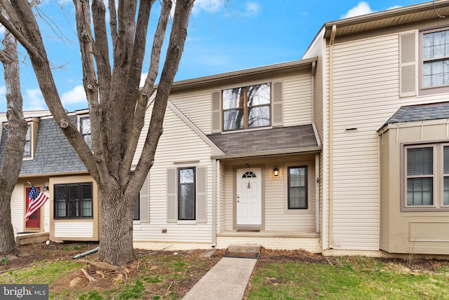 multi unit property featuring roof with shingles