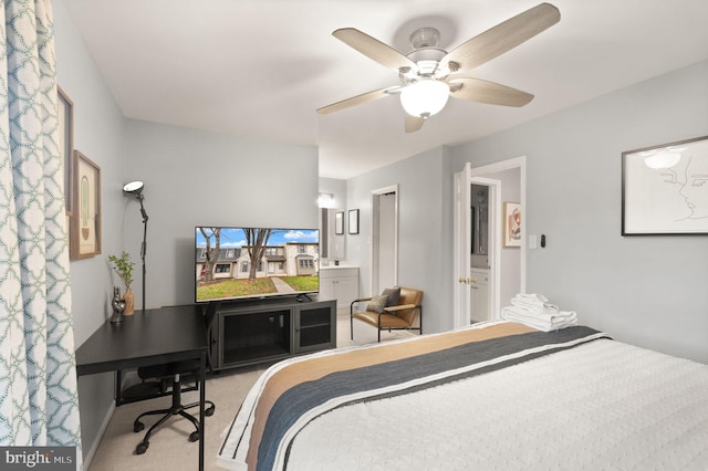 carpeted bedroom with a ceiling fan and connected bathroom