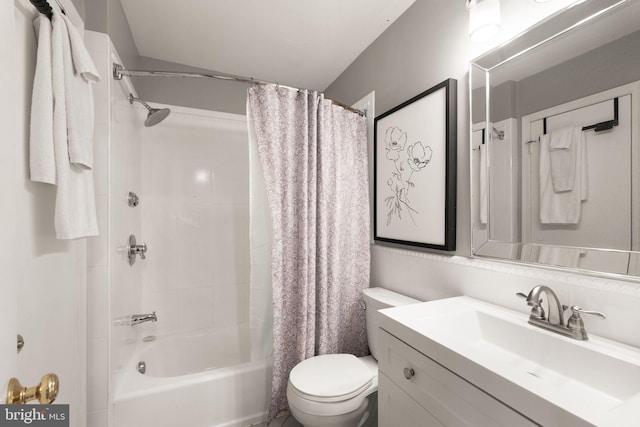 full bathroom featuring shower / bath combo, vanity, and toilet