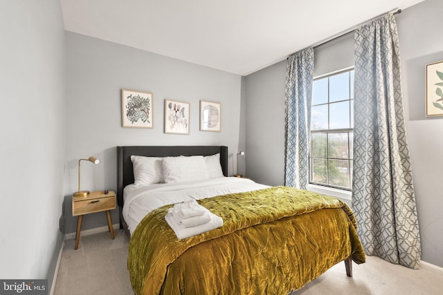 carpeted bedroom featuring baseboards