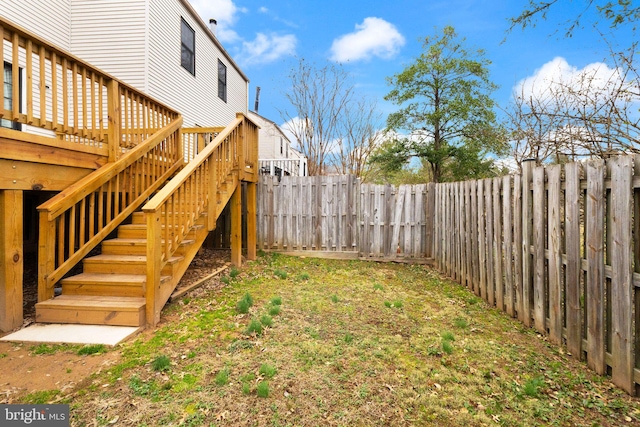 view of yard with stairway and a fenced backyard