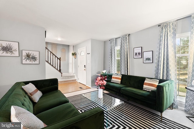 living room with stairway and wood finished floors