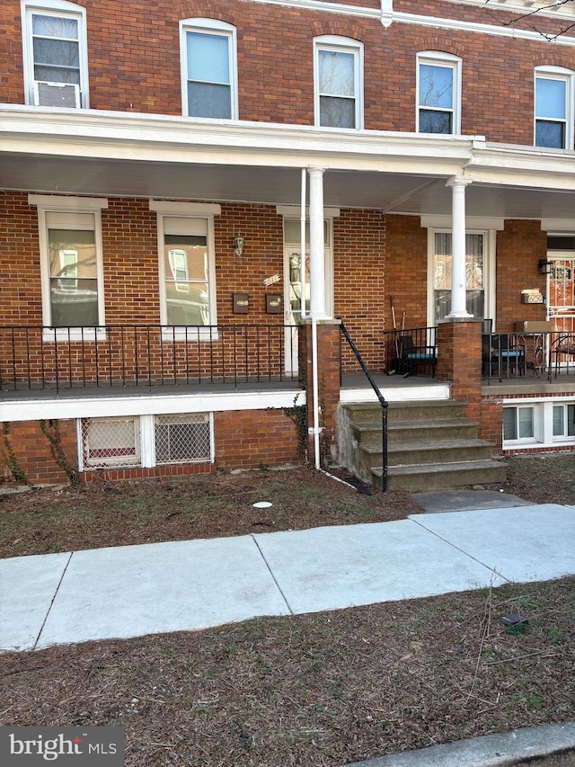 611 E 37th St, Baltimore, MD 21218 - entrance to property with a porch and brick siding