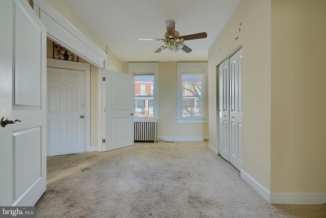611 E 37th St, Baltimore, MD 21218 - unfurnished bedroom featuring carpet floors, radiator heating unit, baseboards, and a ceiling fan