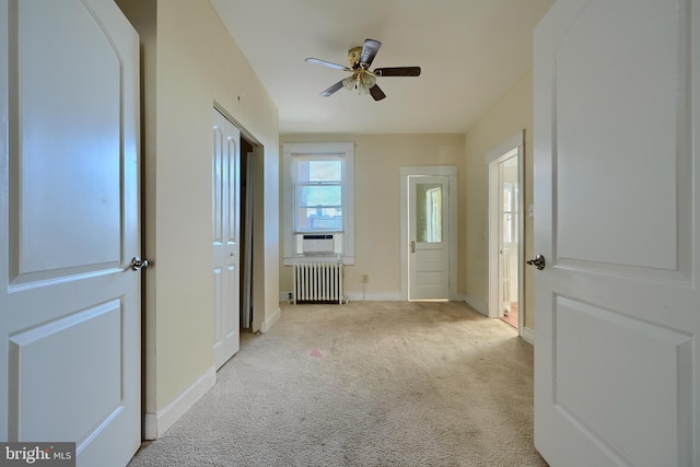 611 E 37th St, Baltimore, MD 21218 - interior space with radiator heating unit, baseboards, a ceiling fan, and light colored carpet