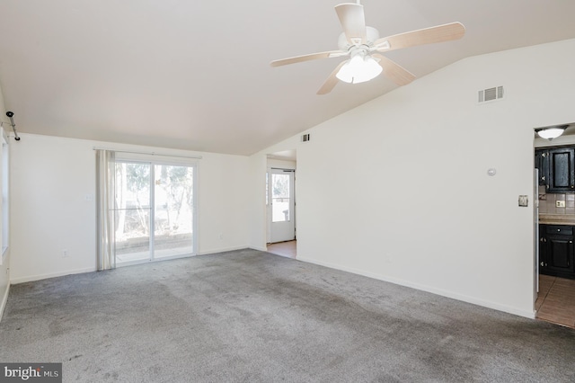 unfurnished living room with visible vents, ceiling fan, baseboards, carpet, and lofted ceiling