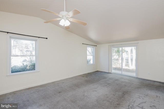 spare room with lofted ceiling, carpet, baseboards, and ceiling fan