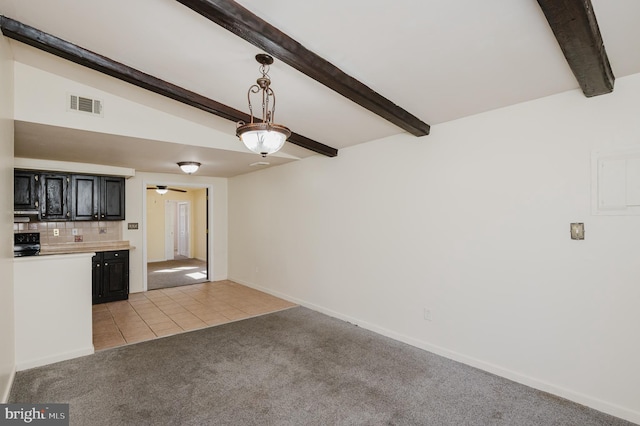 unfurnished living room with beam ceiling, visible vents, light colored carpet, and light tile patterned floors