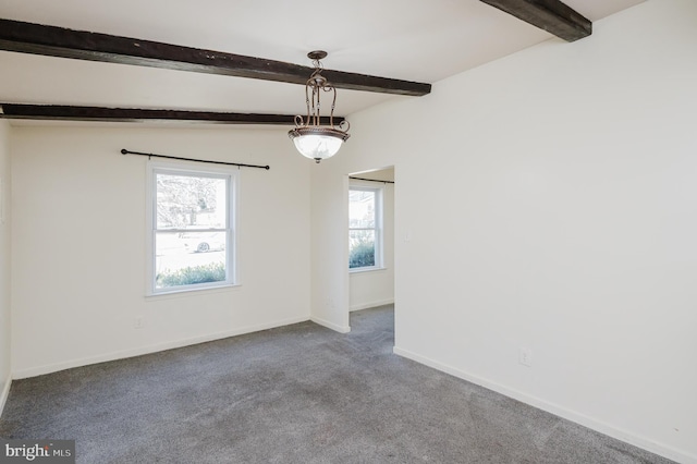 unfurnished room featuring beamed ceiling, baseboards, and carpet