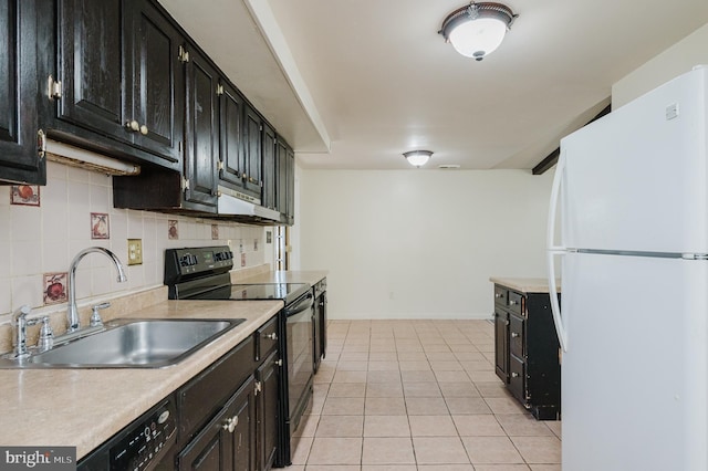 kitchen featuring light tile patterned floors, a sink, black appliances, light countertops, and dark cabinets