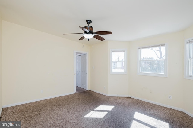 empty room with carpet and baseboards