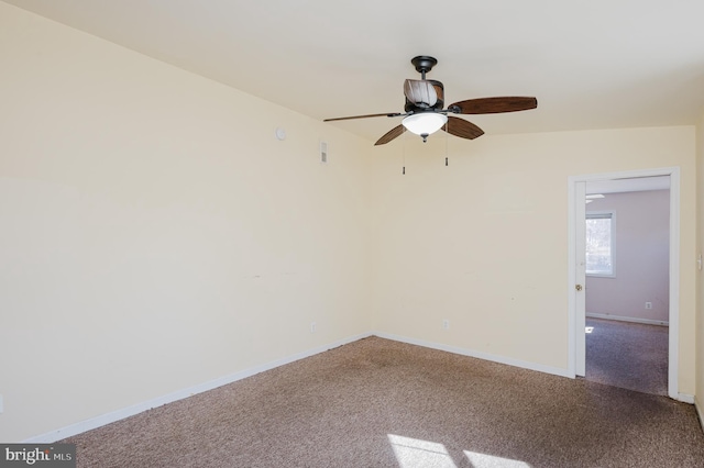 spare room featuring baseboards, carpet, and ceiling fan