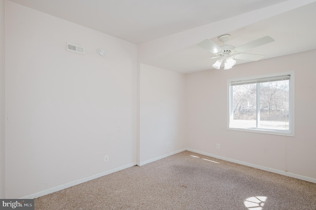 unfurnished room featuring carpet, visible vents, and baseboards