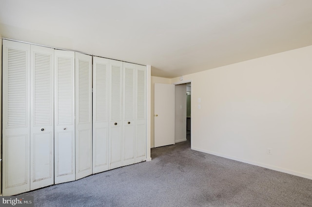 unfurnished bedroom featuring carpet flooring and baseboards