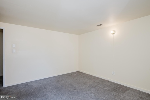 unfurnished room with visible vents, baseboards, and carpet