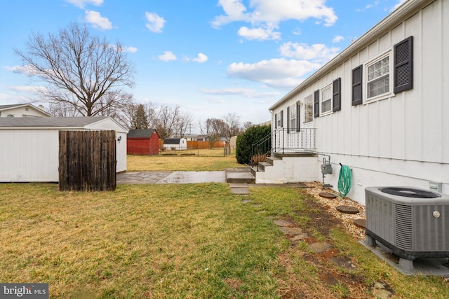 view of yard with an outbuilding, a storage shed, and cooling unit