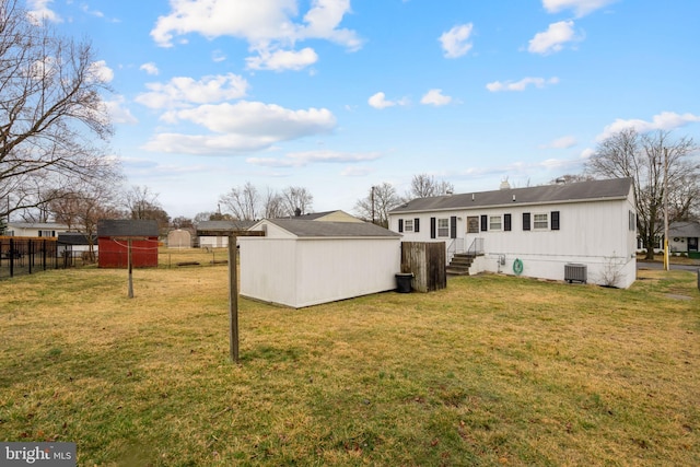 back of property with entry steps, fence, a storage shed, and central air condition unit