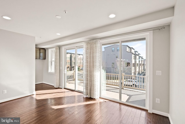 doorway to outside with hardwood / wood-style flooring, recessed lighting, and baseboards