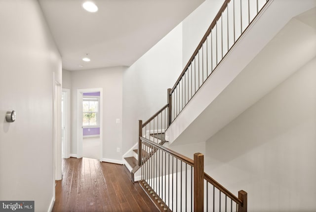 corridor with recessed lighting, baseboards, hardwood / wood-style floors, and stairs