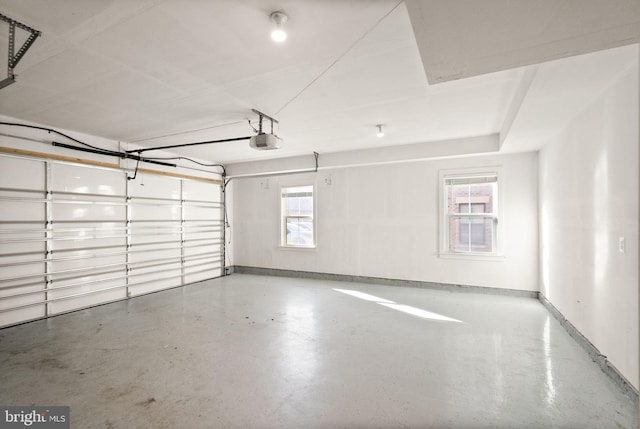 garage with baseboards and a garage door opener