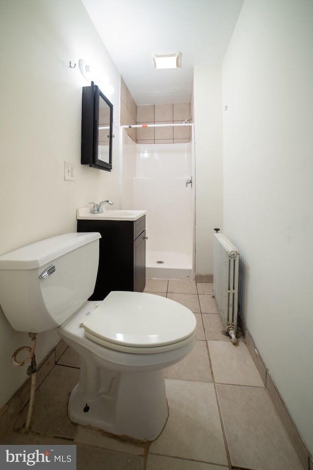 full bathroom featuring a stall shower, toilet, radiator heating unit, tile patterned flooring, and vanity