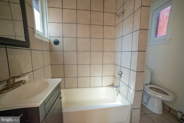 full bathroom with toilet, tile patterned flooring, vanity, tile walls, and shower / bathing tub combination