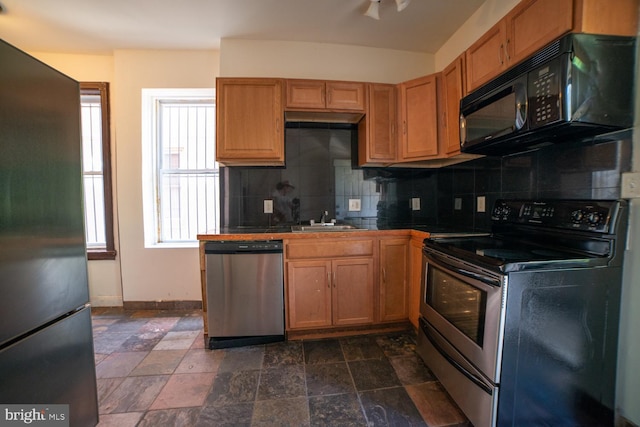 kitchen featuring tasteful backsplash, tile counters, stainless steel appliances, and a sink