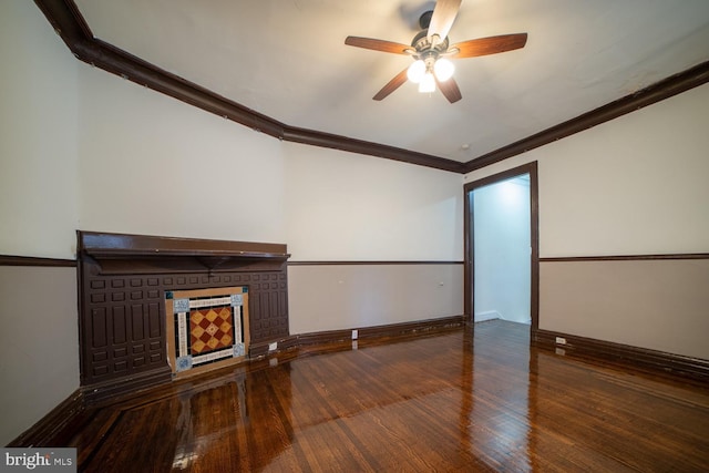 unfurnished living room featuring ornamental molding, a ceiling fan, a fireplace, and hardwood / wood-style flooring