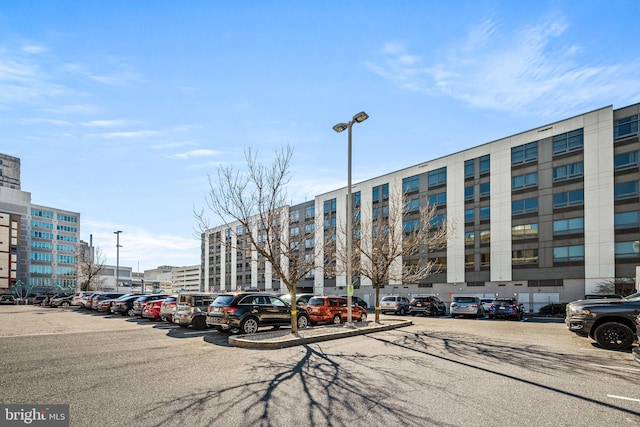 view of building exterior featuring uncovered parking