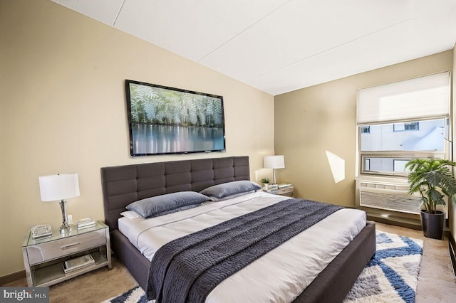 carpeted bedroom featuring lofted ceiling and baseboards