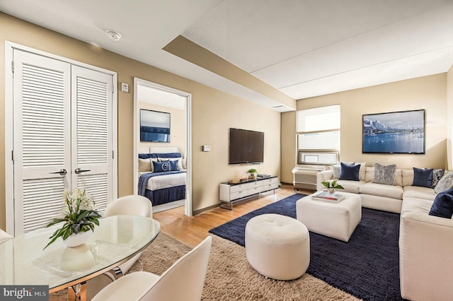 living area featuring light wood-type flooring and baseboards