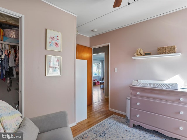 bedroom featuring light wood finished floors, a closet, and baseboards