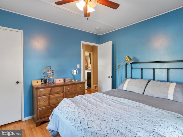 bedroom featuring visible vents, a ceiling fan, and wood finished floors