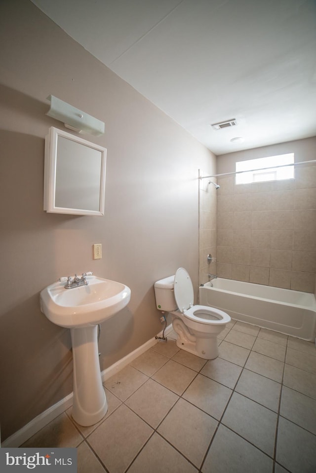 full bath with toilet, bathtub / shower combination, baseboards, and tile patterned floors