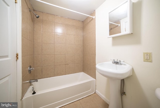 full bathroom featuring tile patterned flooring, washtub / shower combination, and a sink