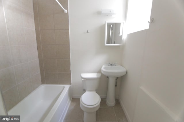 bathroom with tile patterned flooring, baseboards, shower / bathing tub combination, and toilet