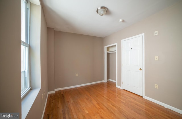 unfurnished bedroom featuring light wood-style flooring and baseboards