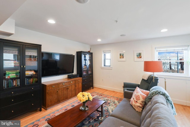 living room with baseboards, light wood-style flooring, and recessed lighting