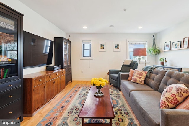 living room featuring light wood-type flooring, a healthy amount of sunlight, and recessed lighting