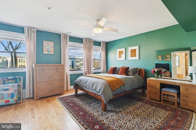 bedroom with ceiling fan and hardwood / wood-style flooring