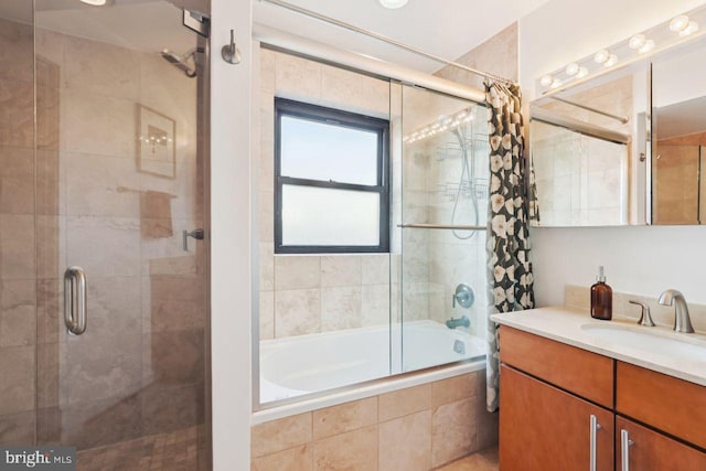 full bathroom featuring tiled shower / bath and vanity