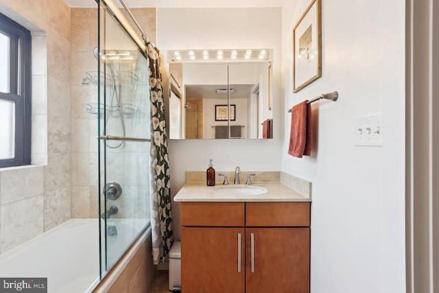 bathroom featuring vanity, toilet, and bath / shower combo with glass door