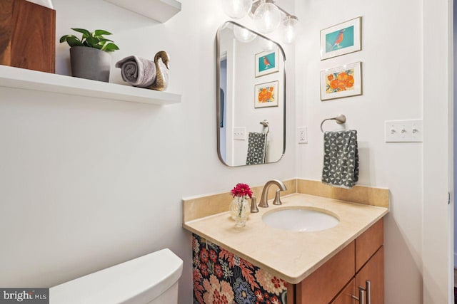 half bathroom with vanity and toilet