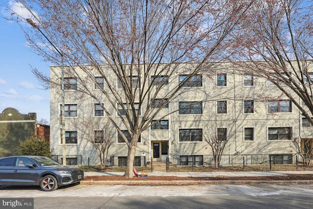 view of building exterior featuring a fenced front yard