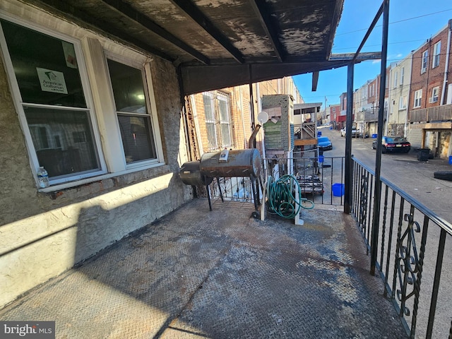 view of patio / terrace with a balcony and grilling area